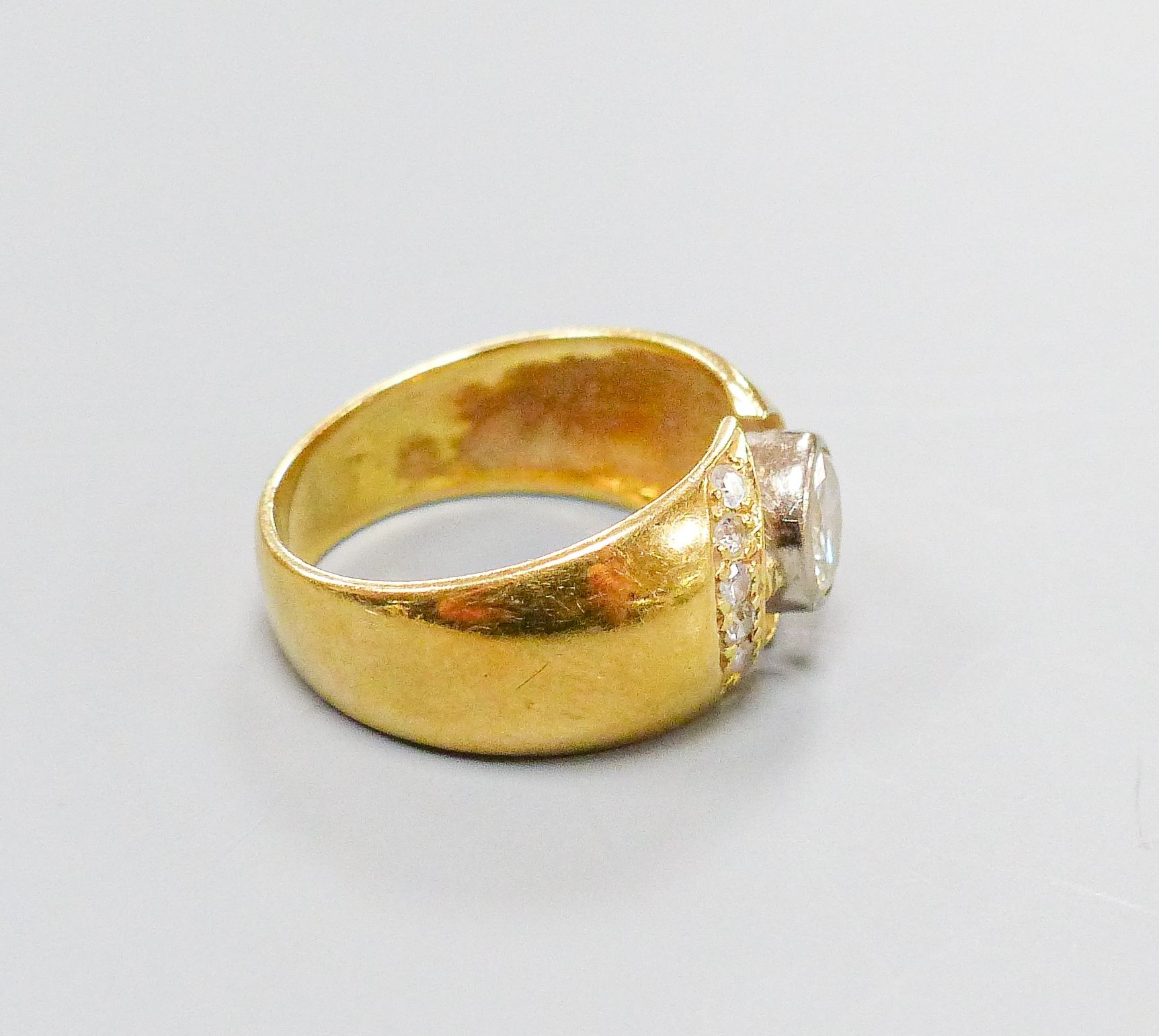 A modern 750 yellow metal and single stone diamond ring, with diamond set open work setting, size M, gross 6.4 grams.